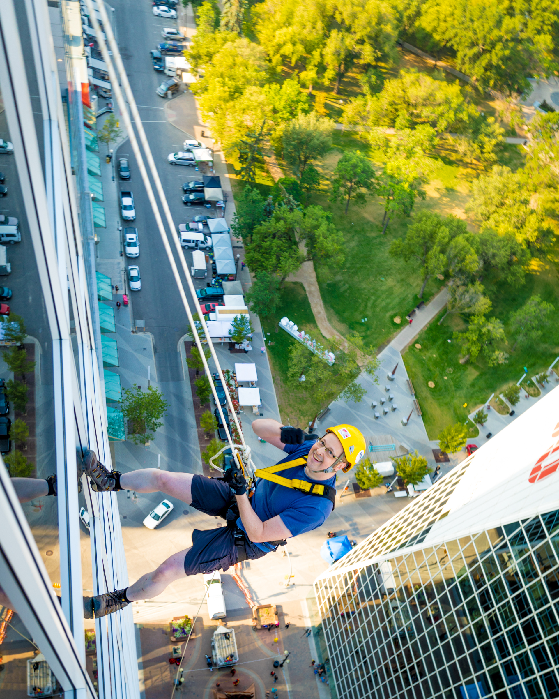 Aaron Hoos rappelling down a building